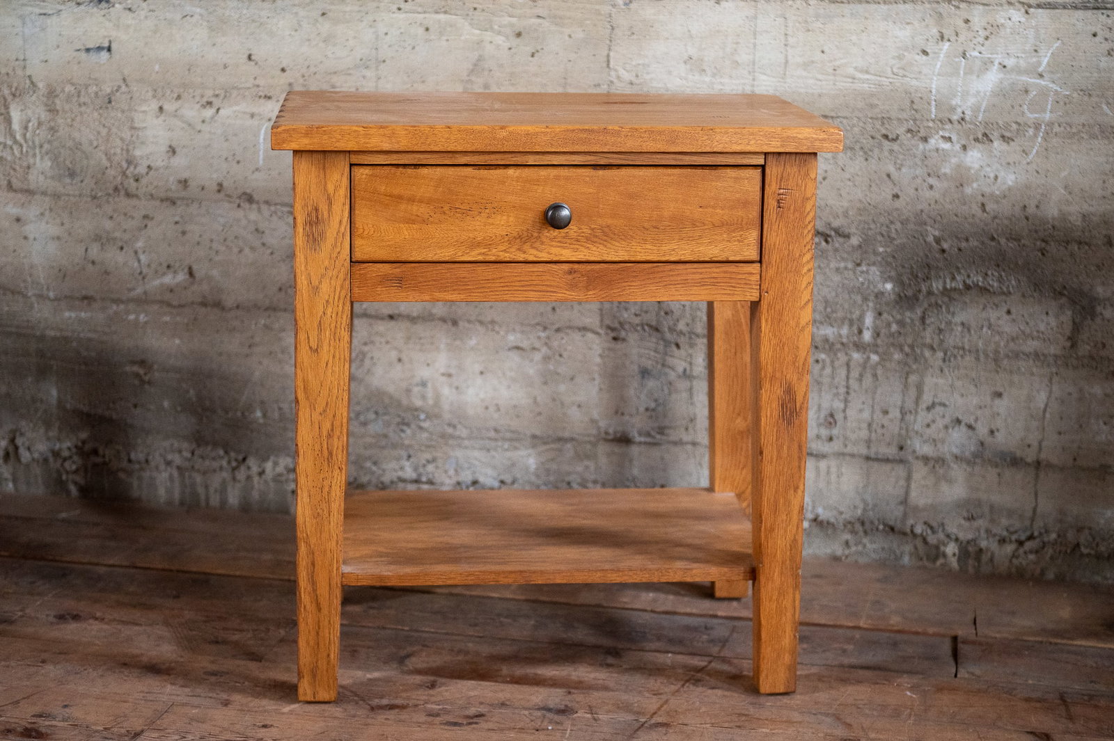 SOLID WOOD NIGHTSTAND: A well-made solid wood nightstand with a single dove-tailed drawer. Incredibly solid and heavy with solid Oak legs. No maker's mark, but was built to last. Measures 30'' H x 28'' W x 18'' D.