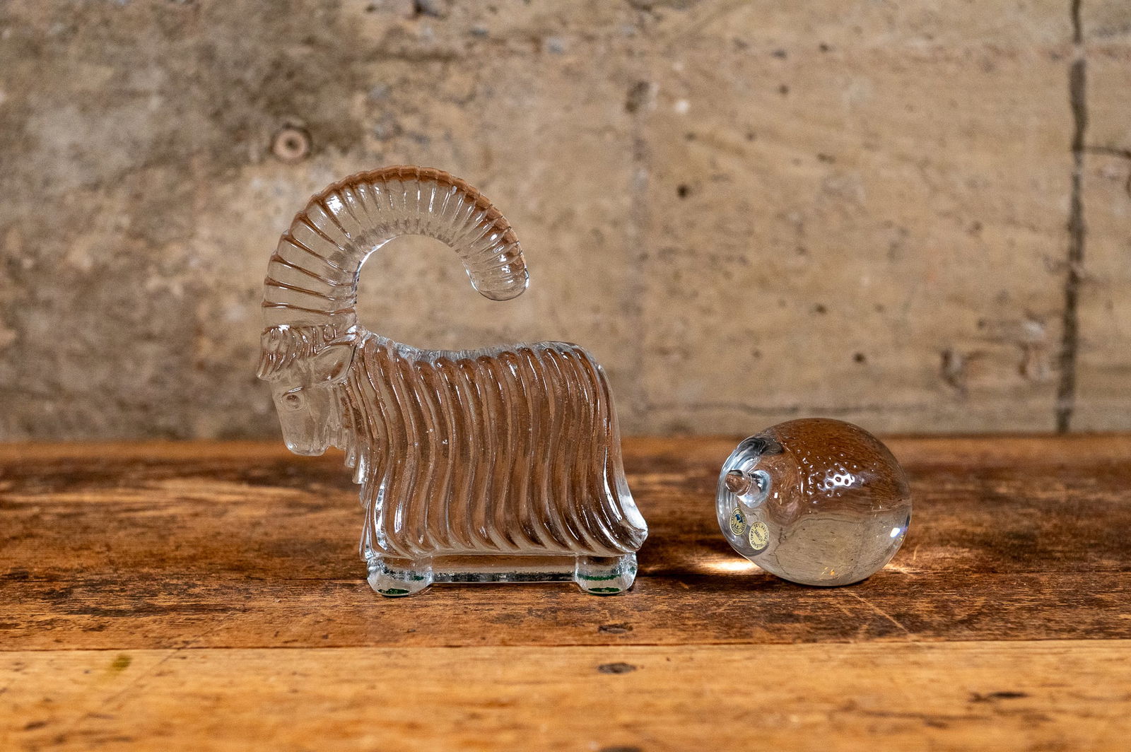 SCANDINAVIAN CRYSTAL AND GLASS ANIMAL SCULPTURES, HOLMEGAARD & KOSTA BODA: A pair of Mid-Century Scandinavian animal sculptures. A crystal hedgehog sculpture created Holmegaard of Denmark, and a Julbock or Yule Goat glass sculpture, a Scandinavian Christmas tradition, design