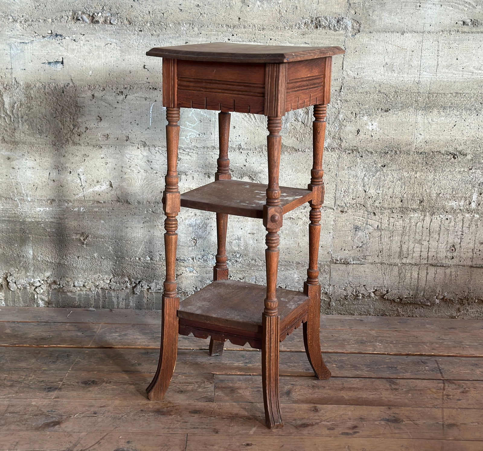 VICTORIAN THREE-TIER TABLE: A Victorian three-tier table with minor wear throughout shown in photos. A sturdy antique piece, this table makes for a wonderful accent piece. This table measures 34.5'' H x 14'' W x 14'' D.