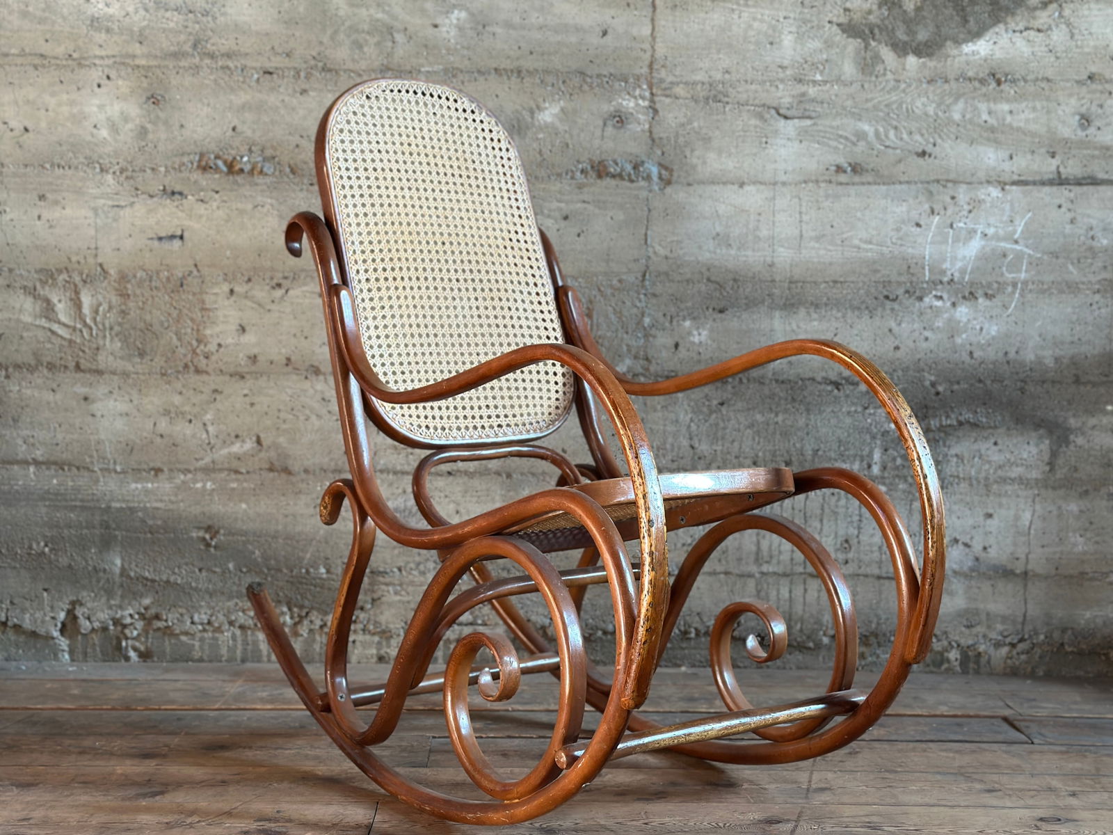 MICHAEL THONET, BENTWOOD & CANED ROCKING CHAIR: This lot features a stunning original Thonet Bentwood & caned rocking chair in very good overall condition. Marked "Thonet" on the back as shown in photos. This Thonet rocking chair measures, 41''