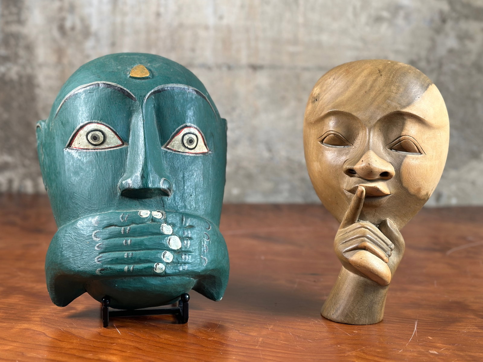 PAIR OF WOODEN MASKS, INDONESIA: This lot features a pair of vintage wooden masks, made in Indonesia. The largest mask measures, 10'' H x 6.5'' W x 3'' D.