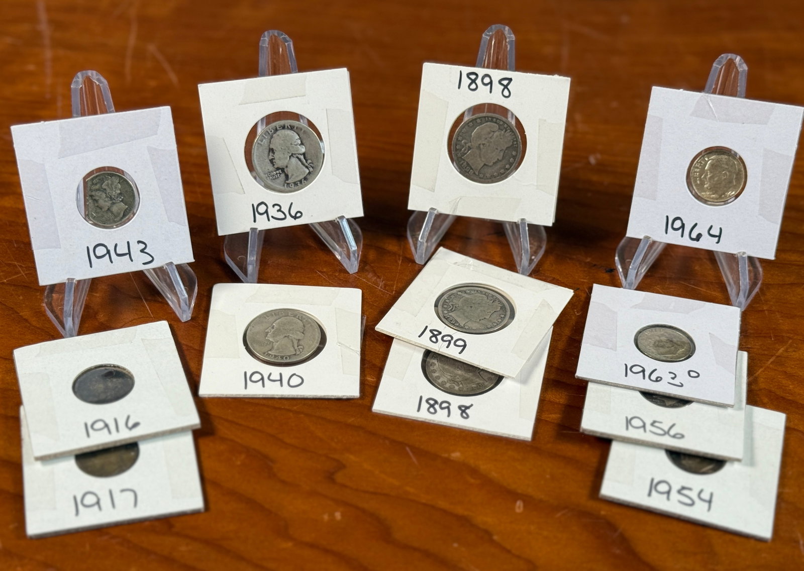 SILVER QUARTERS, MERCURY DIMES, & ROOSEVELT DIMES: This lot features a variety of silver quarters, Mercury dimes, and Roosevelt dimes from various years and kept in protective slips.