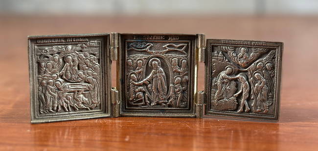 RUSSIAN TRINKET ICON: This lot features an antique trifold Russian trinket icon in good condition. A “brass Russian icon&rdquo; is a religious image, typically depicting a Christian saint or scene from the Bible, crafted