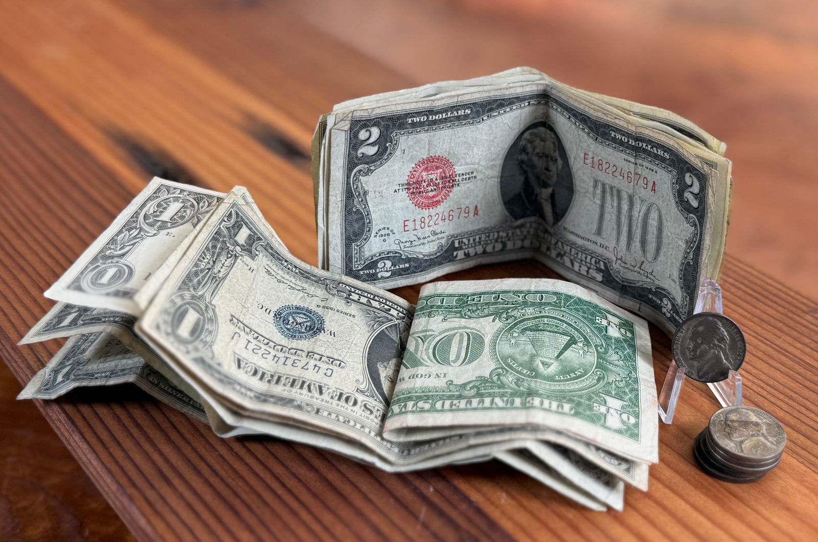 WAR NICKELS & CURRENCY COLLECTION: This lot features six (6) 35% silver war nickels, nine (9) $1 bills, and eight (8) $2 bills.