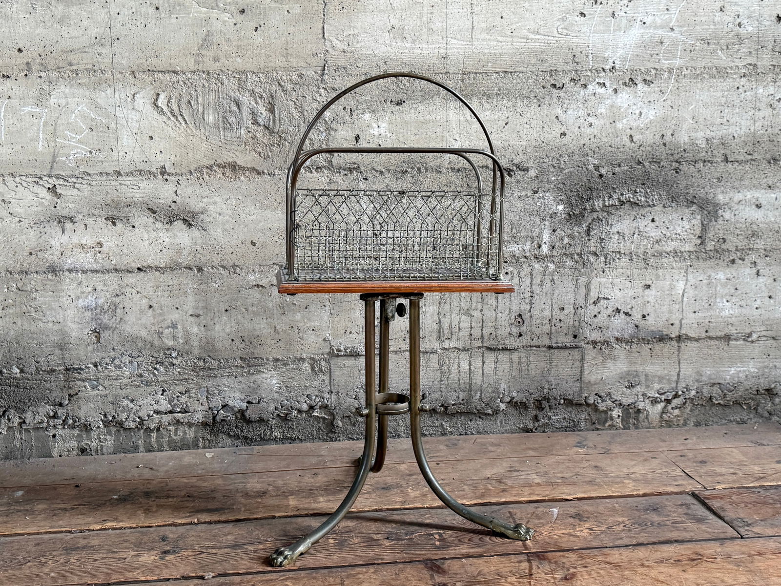 ANTIQUE NEWSPAPER RACK: This lot features an antique newspaper rack that measures, 28'' H x 16'' W x 15'' D. Constructed from brass and wood.