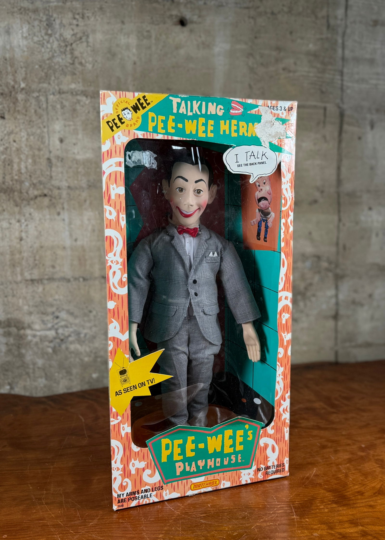MATCHBOX, 1987 TALKING PEE-WEE HERMAN DOLL: This lot features a highly collectible 17-inch doll based on the character from Pee-wee's Playhouse and manufactured by Matchbox in 1987. 