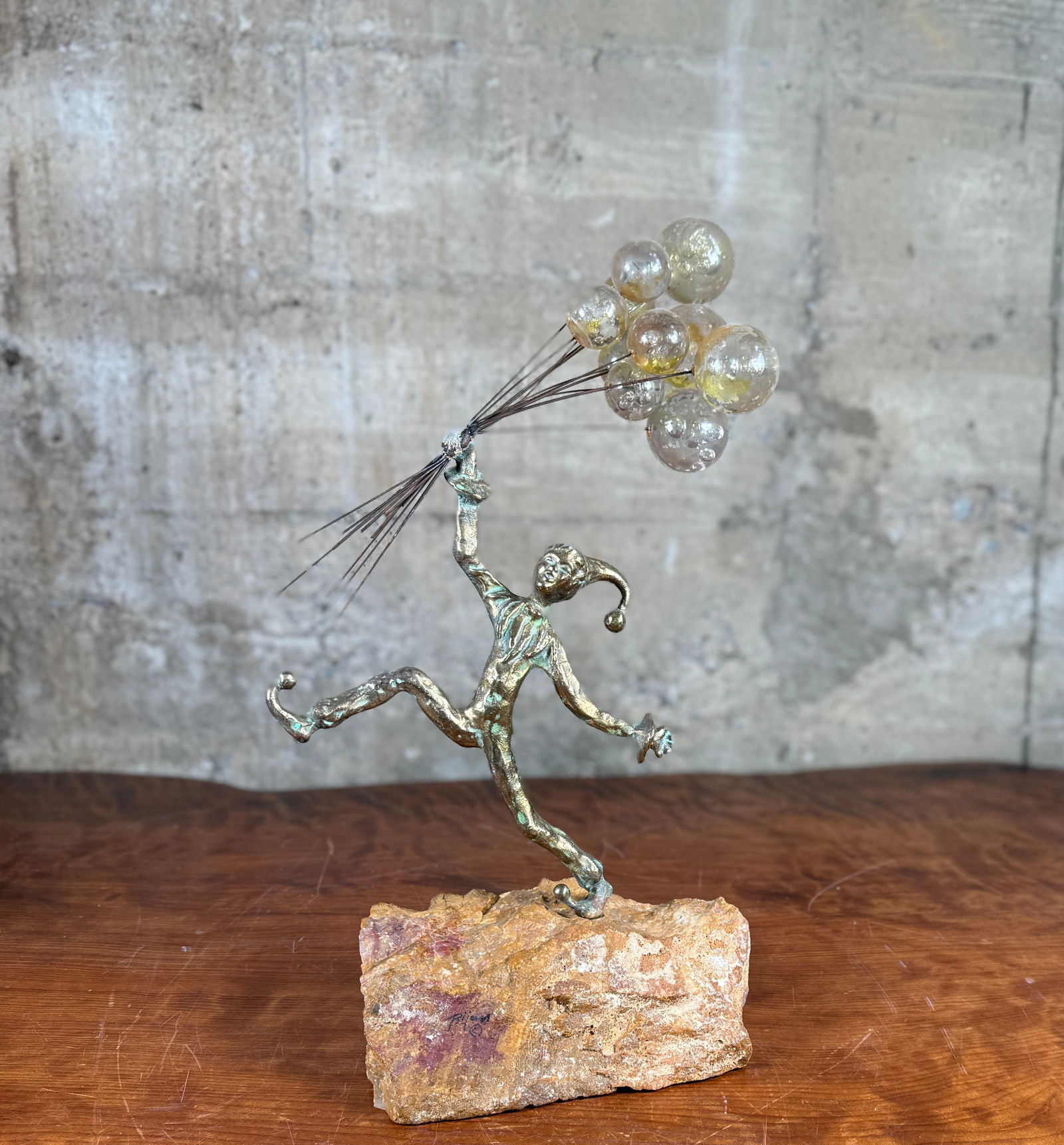 BRIAN BIJAN, BRUTALIST BRONZE SCULPTURE: This lot features a stunning brutalist bronze sculpture by listed artist, Brian Bijan. This sculpture features a whimsical clown figure holding a bouquet of balloons and mounted on a stone base with B