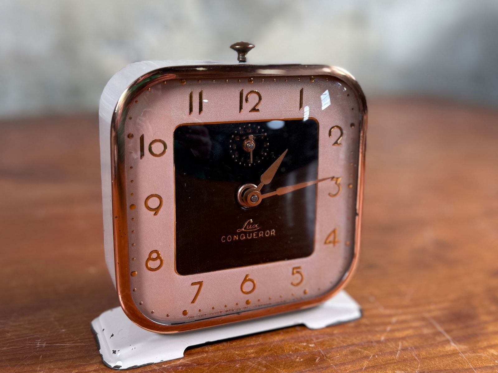 LUX CONQUEROR ALARM CLOCK: This lot features a vintage Lux Conqueror alarm clock, a collectible wind-up timepiece manufactured in the 1940s. Tested and in working condition.
