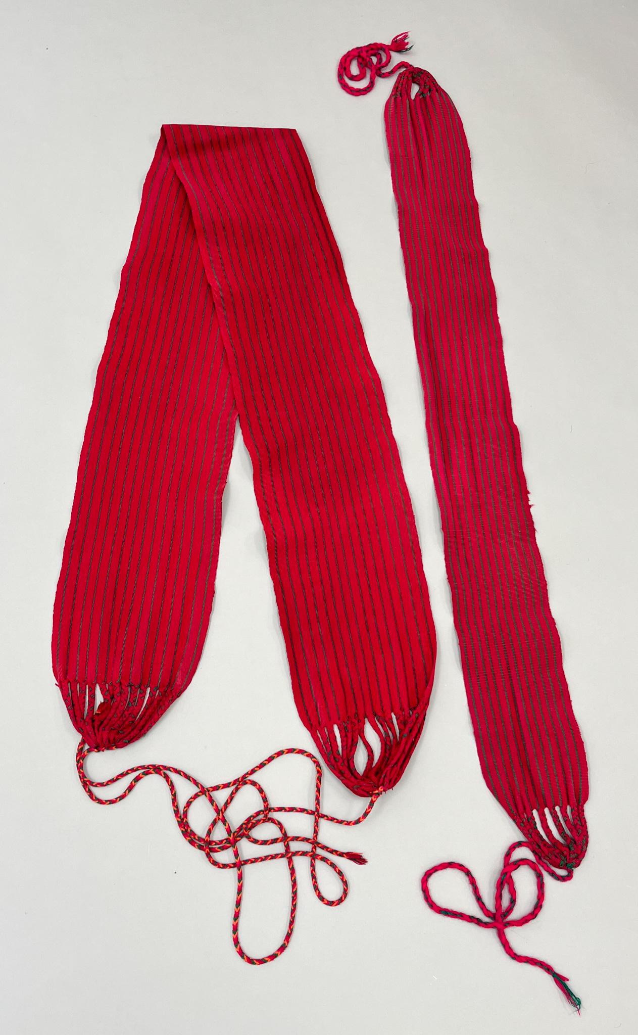 Guatemala, Group of (2) Vintage Woven Cotton "Fajas" Sashes: Guatemala, group of (2) vintage woven cotton "Fajas" sashes, red with narrow green stripes, 64"l x 7"w, 39"l x 4.5"w PROVENANCE:From the estate of Professor Philip Gould, New York
