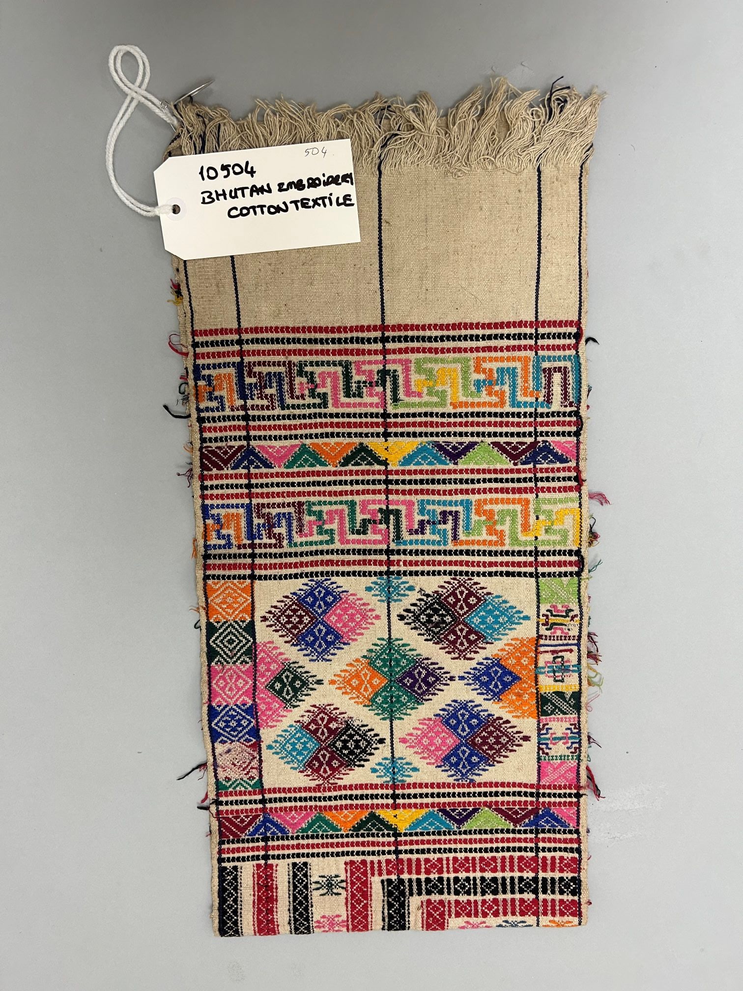 Bhutan, Embroidered Cotton Textile: Bhutan, embridered coarse cotton textile, 45"l X 11"w Provenance: From the Estate of Dr. Philip Gould , New York