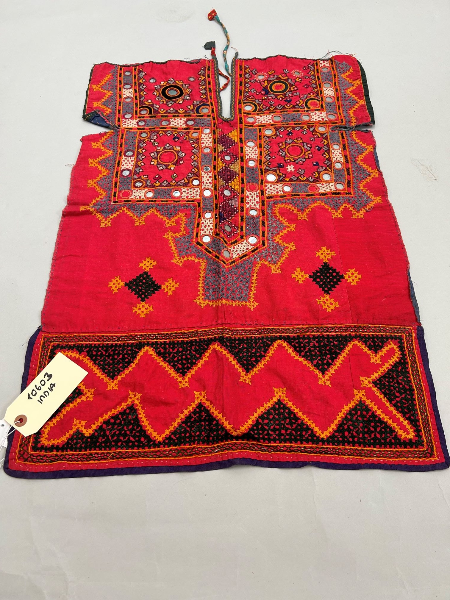 India, Gujarat, Cotton Accessory with Mirror Embroidery Pattern: India, Gujarat, cotton accessory with mirror embroidery pattern, 31"l x 22"w Provenance: From the estate of Dr. Philip Gould , New York