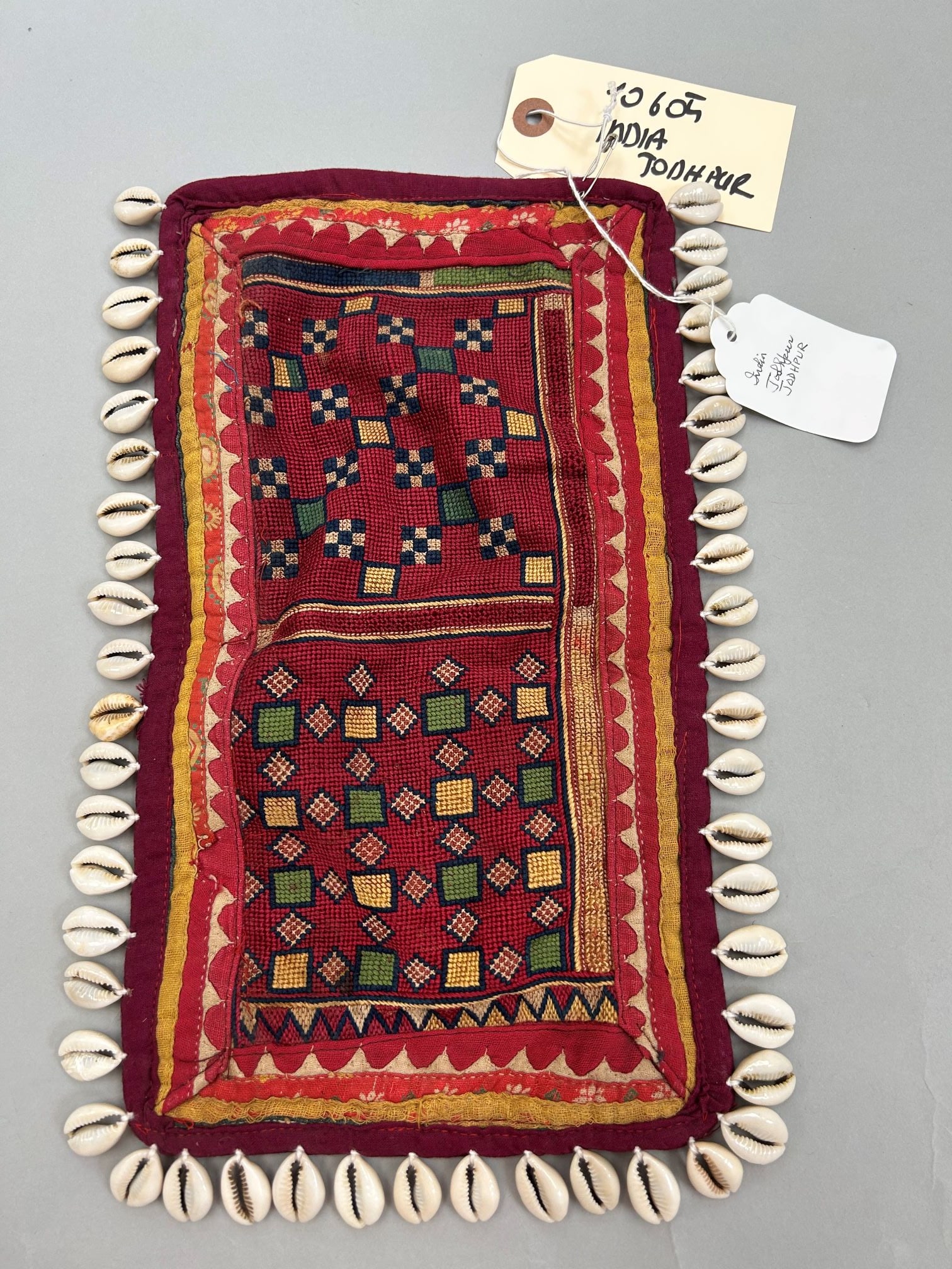 India, Johdpur, Embroidered Tapestry with Cawrie Shells: India, Johdpur, embroidered tapestry with cawrie shells, 13"l x 7.5"w Provenance: From the estate of Dr. Philip Gould , New York