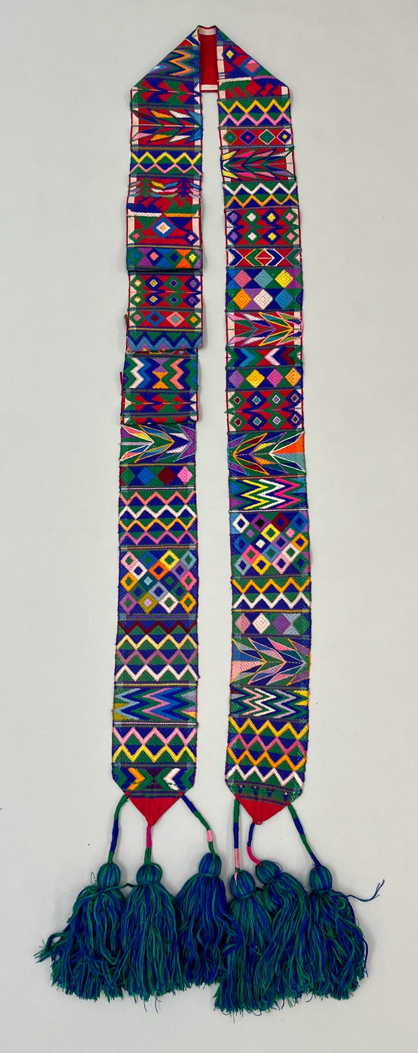 Aguacatan, Hehuetenango, Vintage Back-Strap Loom Woven Cotton "Cinta" Hair Ribbon: Aguacatan, Department of Hehuetenango, Guatemala, vintage back-strap loom woven cotton "Cinta" hair ribbon with tassels, traditional red ground, multicolor symbolic embroidery pattern, 112"l x 4"w PRO