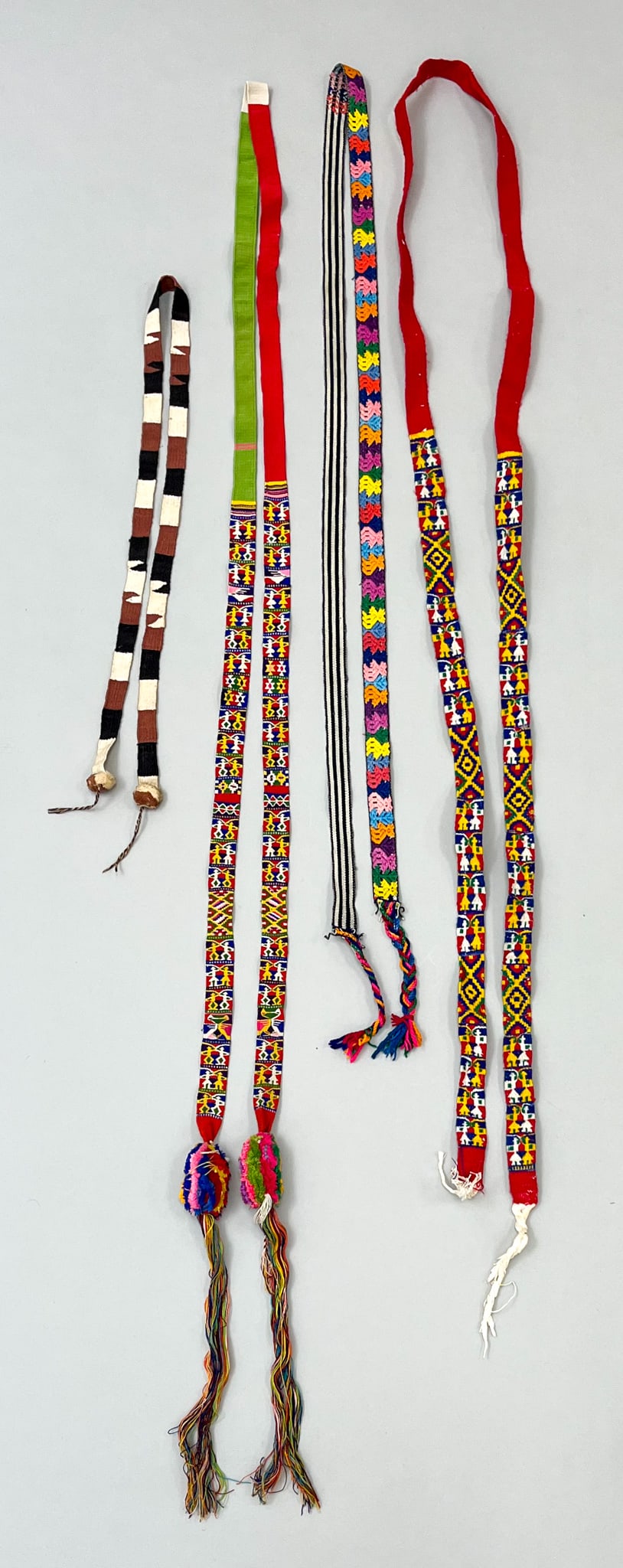 Totonicapan, Almolonga and Santiago Sacatepequez, Guatemala, Group of (4) Vintage Woven Cotton: Totonicapan, Almolonga, Santiago Sacatepequez, Guatemala, group of (4) vintage woven cotton "Cintas" hair ribbons, embroidered with vibrant earth tones, figures, and geometric symbolic pattern, larges