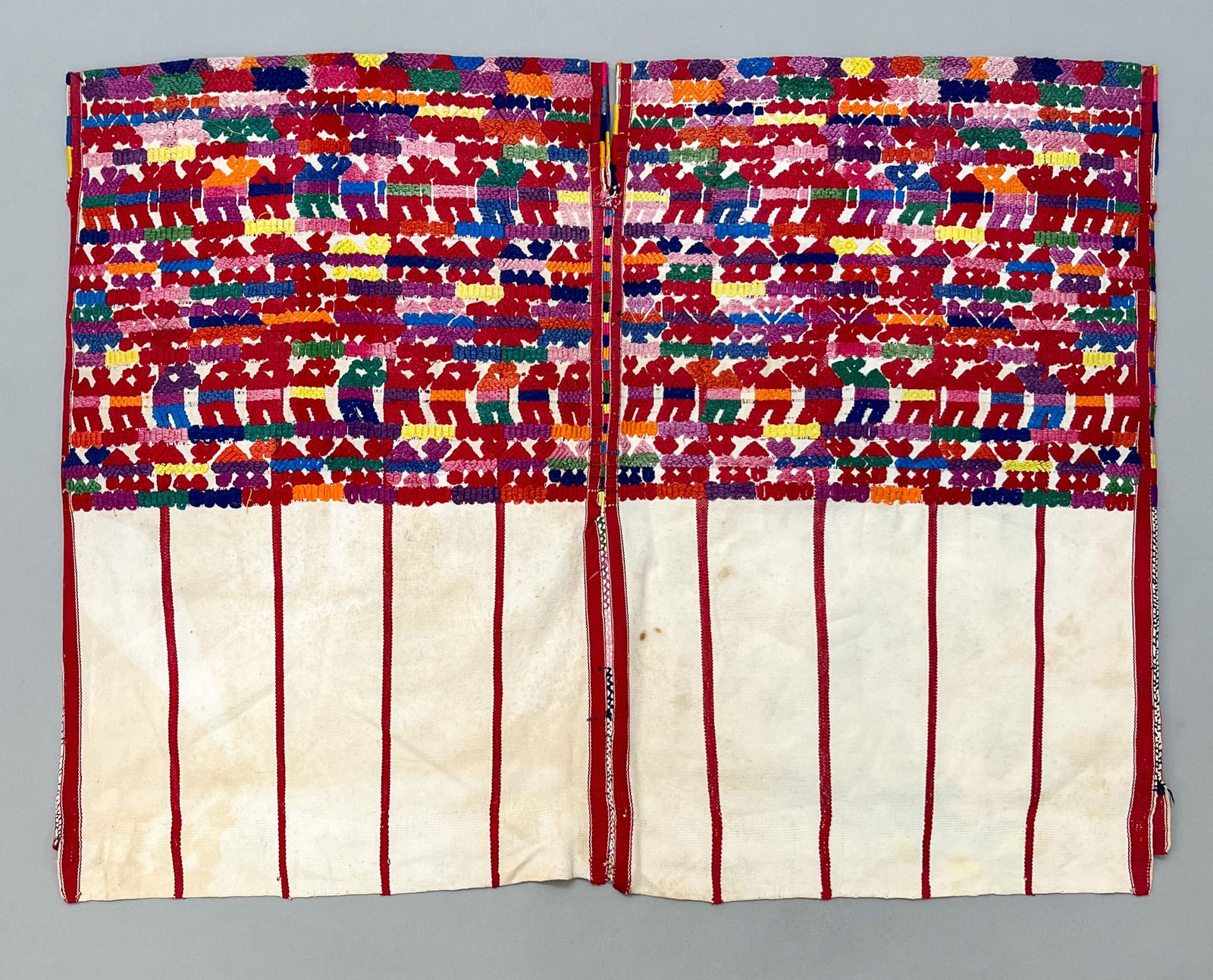 Santiago Sacatepequez, Sacatepequez Department, Guatemala, Vintage Woven Cotton "Huipil" Tunic: Santiago Sacatepequez, Sacatepequez Department, Guatemala, vintage woven undyed cotton "Huipil" tunic, red stripes with symbolic multicolor abstract animals pattern, 28"l x 35"w PROVENANCE:From the es