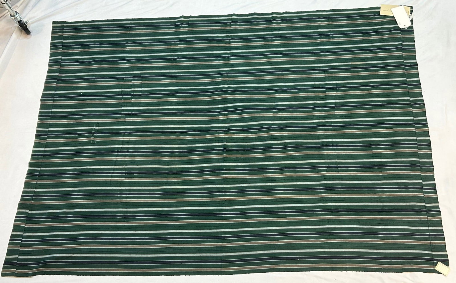 Nigeria Strip Woven Cotton Textile: Nigeria, West Africa, strip woven cotton textile with alternating narrow bands of green, blues and beige, mid-20th century. Believed exhibited, 78" x 55" PROVENANCE: From the estate of Dr. Philip Goul