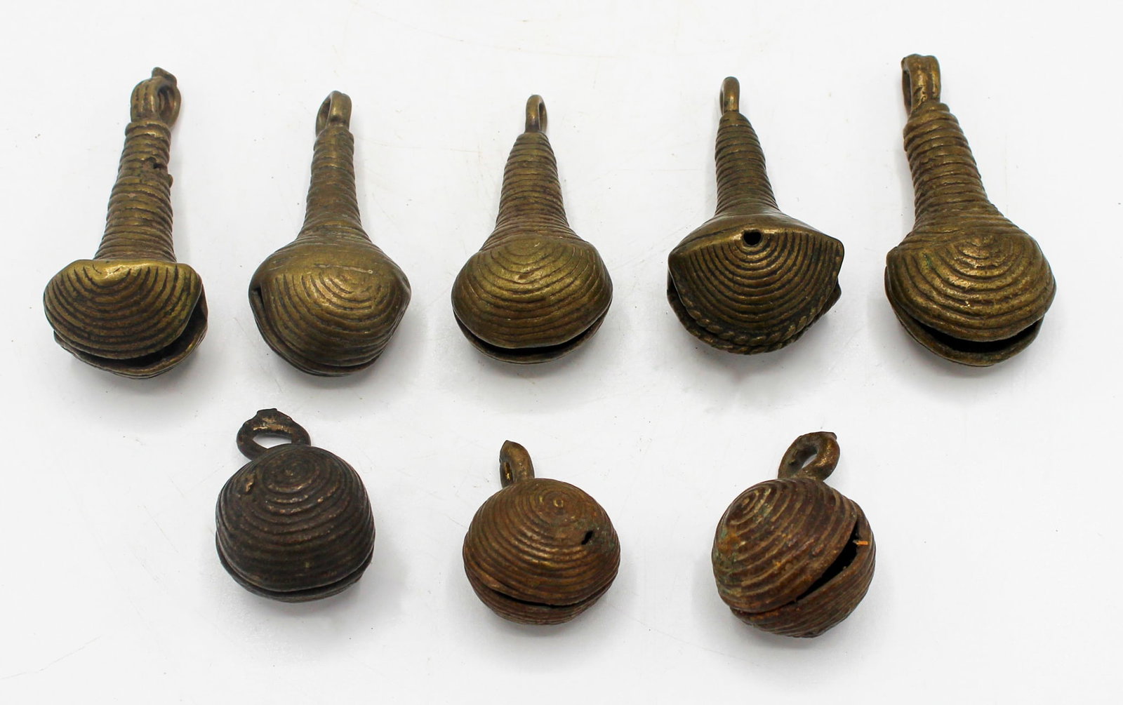 Group of (8) Bells, Yoruba culture, Nigeria, West Africa: Group of (8) bells, Yoruba culture, Nigeria, West Africa, likely first half of the 20th century. Appromate size, 2.25"H (largest). PROVENANCE: From the estate of Dr. Philip Gould, New York