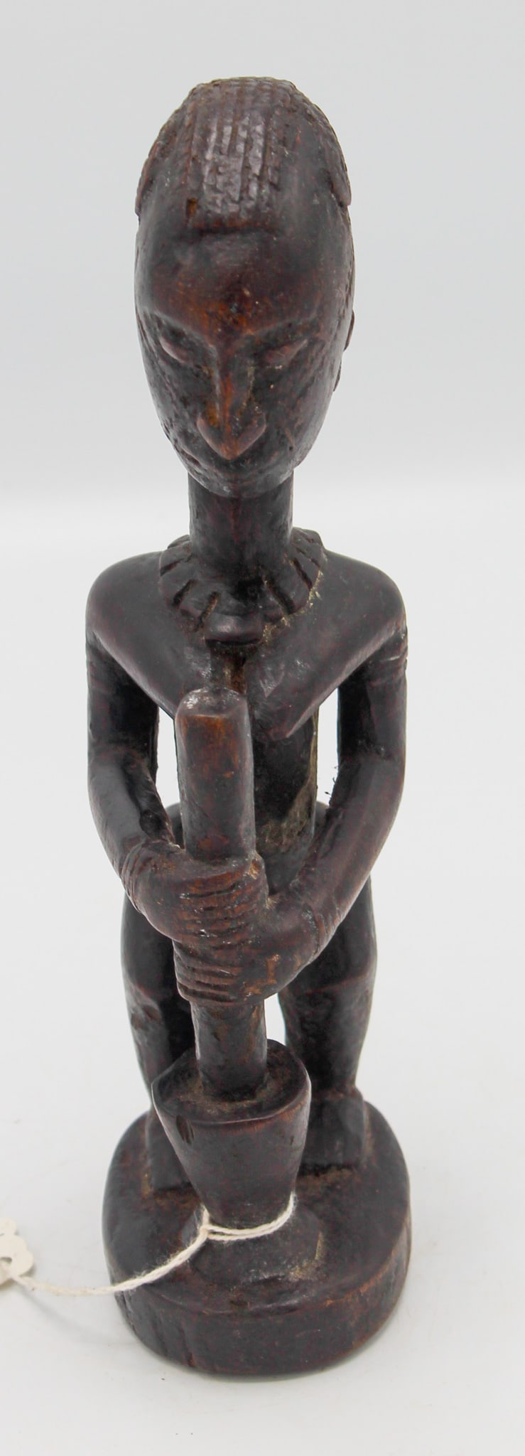 Dogon People Style, Carved Wood Figure Using Pestle and Mortar, Mali, West Africa: Dogon people style, carved wood figure using pestle and mortar, Mali, West Africa, 20th century. Approximate size, 9.1"H. PROVENANCE: From the estate of Dr. Philip Gould, New York