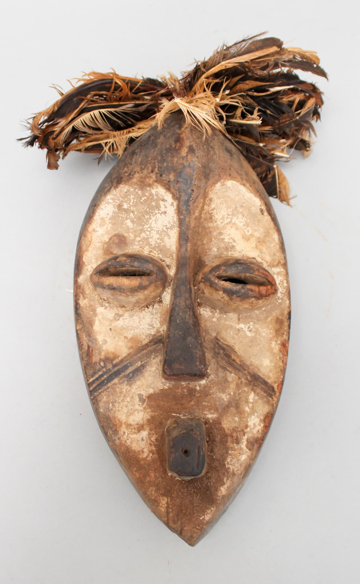 Lego Peoples Style, Carved Wood Mask with Feathers, Democratic Republic of the Congo, Central Africa: Lego peoples style carve wood mask with feathers, Democratic Republic of the Congo, Central Africa, 20th century. Approximate size, 13.5"H (excluding feathers). PROVENANCE: From the estate of Dr. Phil