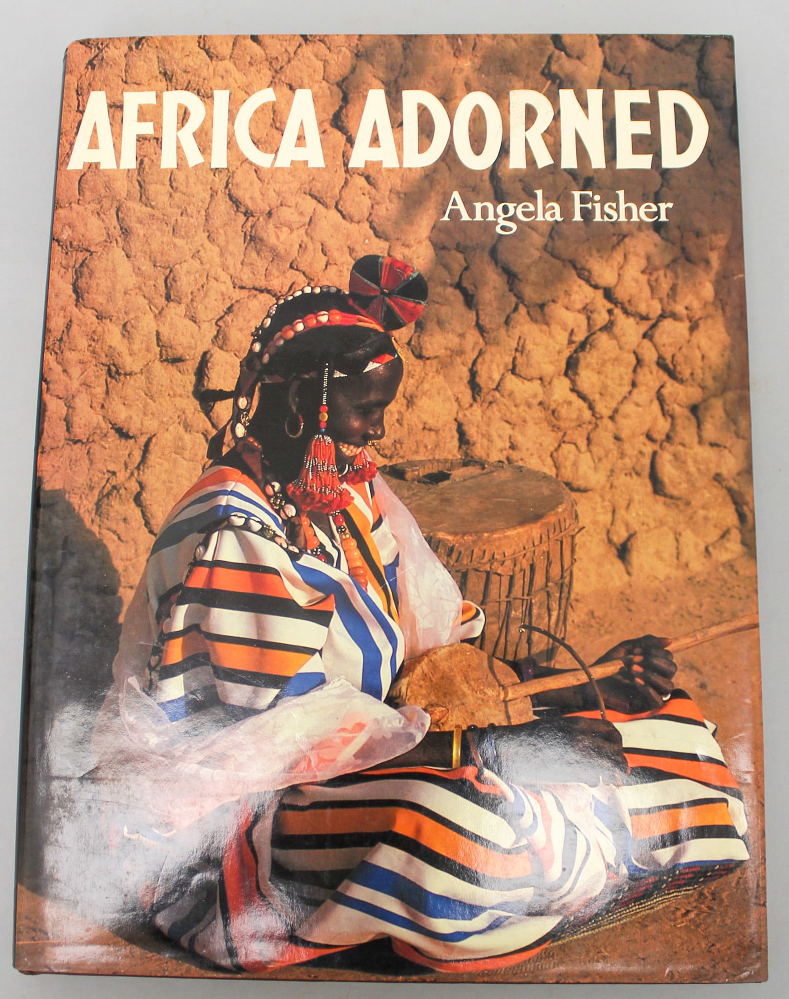 Africa Adorned by Angela Fisher: Africa Adorned by Angela Fisher, hardback. Approximate dimensions 14.25"H x 10.75"W, 304 pages. PROVENANCE: From the estate of Dr. Philip Gould, New York