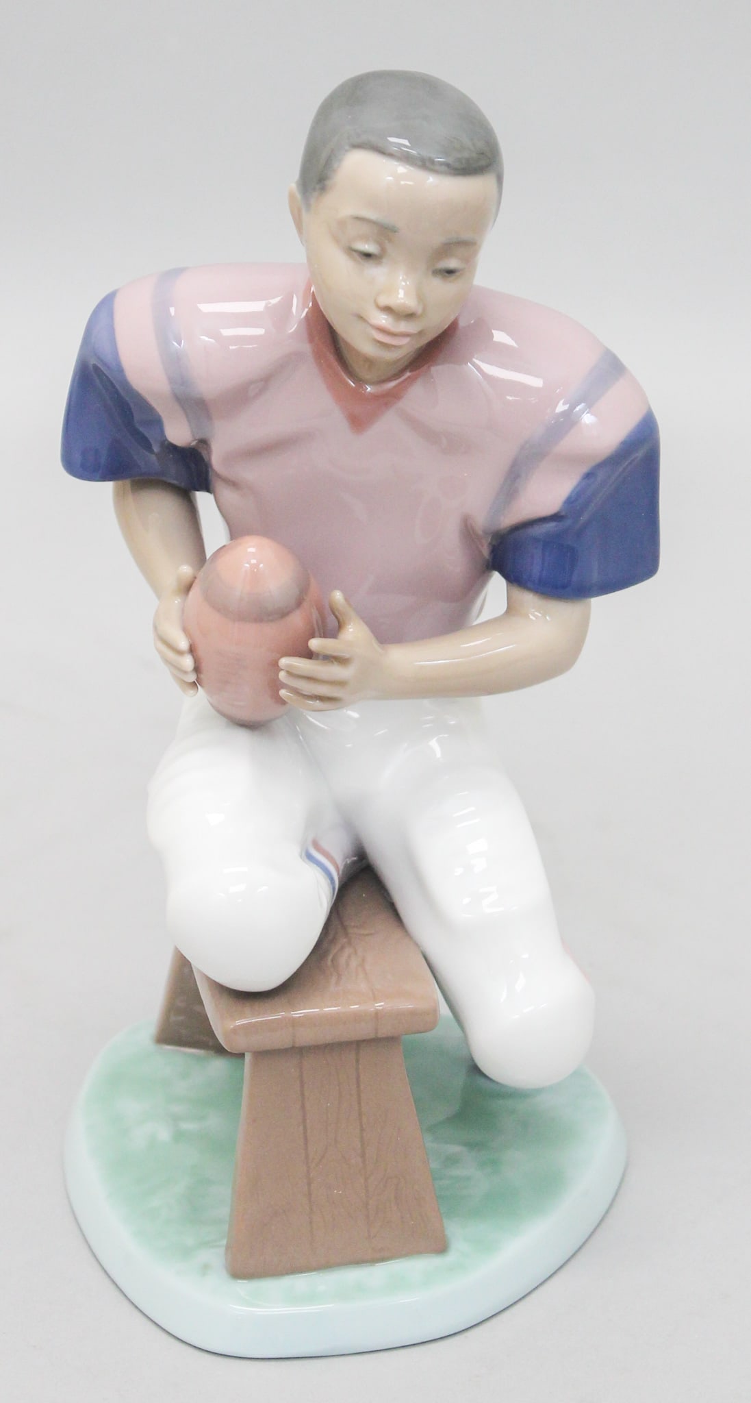 Lladro "Football Star" 6135 Black Legacy Figurine: Lladro "Football Star" 6135 Black Legacy figurine, mark on bottom Lladro, Hand Made in Spain, Daisa 1993, 6135 G-21F, 9"h x 4.25"w x 4.75"d , in original box 8"h x 13.5"w x 9"d