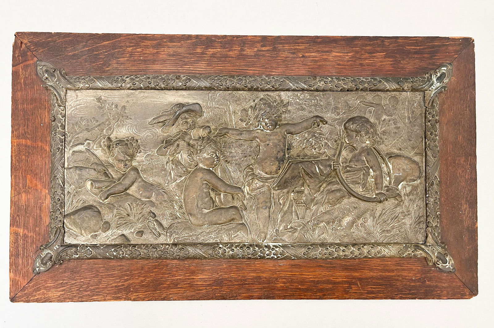 Vintage Engraved Metal Wall Hanging Plaque, Unsigned: Wall hanging plaque with engraved metal with angel motifs, embedded on wooden frame, unsigned, frame size 11.5"h x 20.5"w and sight size 8"h x 16.5"w