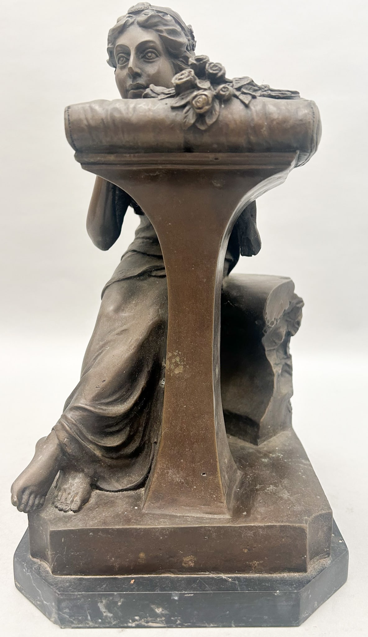 After Pierre Jules Mene, Relaxing Lady Sculpture on Marble Base: A bronze sculpture depicting a lady relaxing with her chin atop a cushioned pedestal beside flowers, recast/reproduction on a marble base 0.75"h x 7"w x 8"d and sculpture 11"h x 6"w x 7.5"d