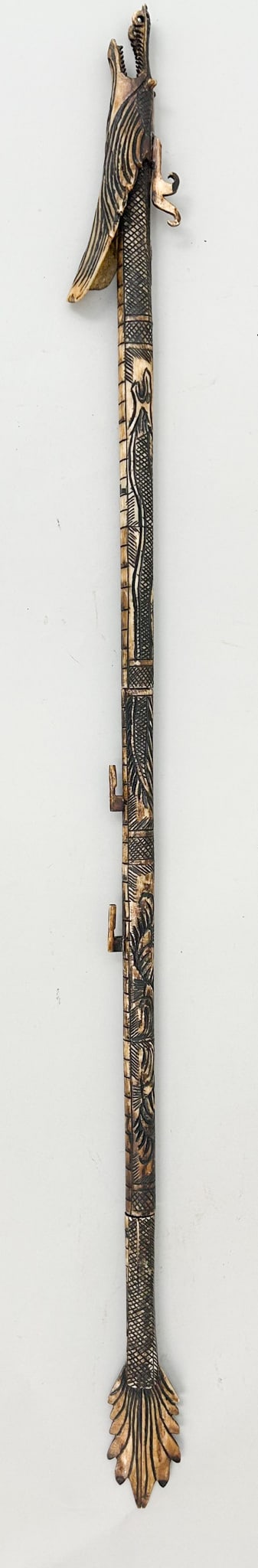 Vintage, Long Bone Blowgun Etched with a Crocodile and Fish, Borneo, Indonesia: A very long bone blowgun etched with a crocodile and fish, made in three parts, the dragon shape would have been used with darts, Borneo, Indonesia, blowgun size 46.5"l