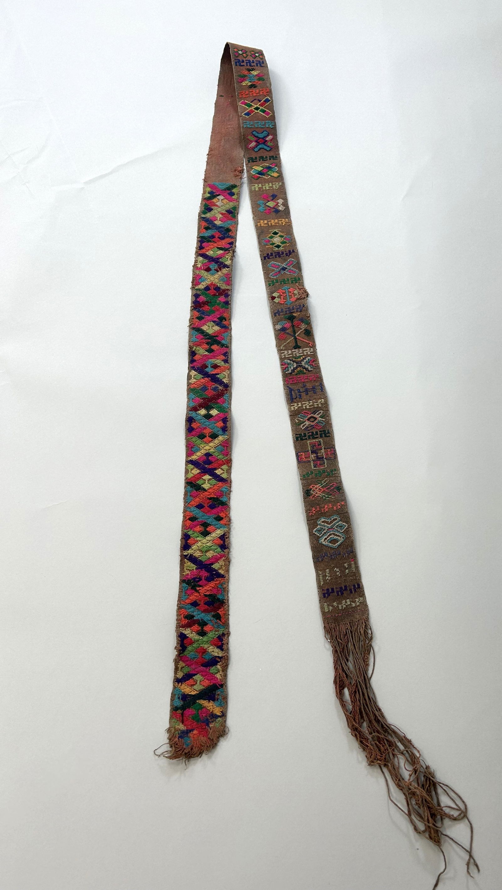 Bhutan Kera Embroidery Cotton Belt: Bhutan Kera Embroidery Cotton Belt, 72"l x 2"w (84"l x 2"w with fringes) Provenance: From the estate of Dr. Philip Gould , New York