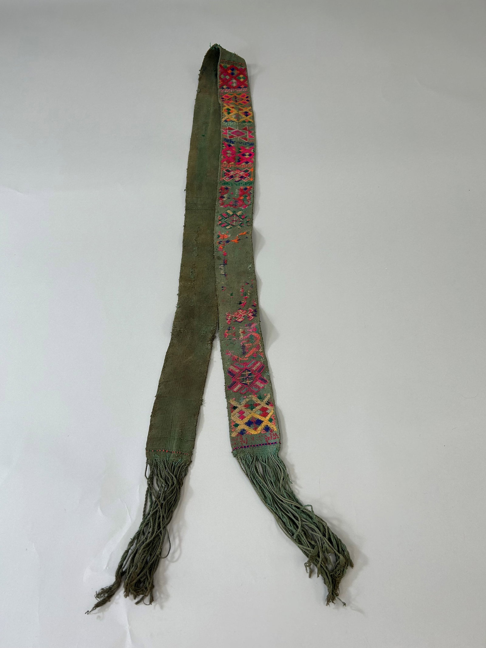 Bhutan Kira Embroidery Cotton Belt: Bhutan Kira Embroidery Cotton Belt, 68"l x 3"w (86" l with fringes) Provenance: From the estate of Dr. Philip Gould , New York