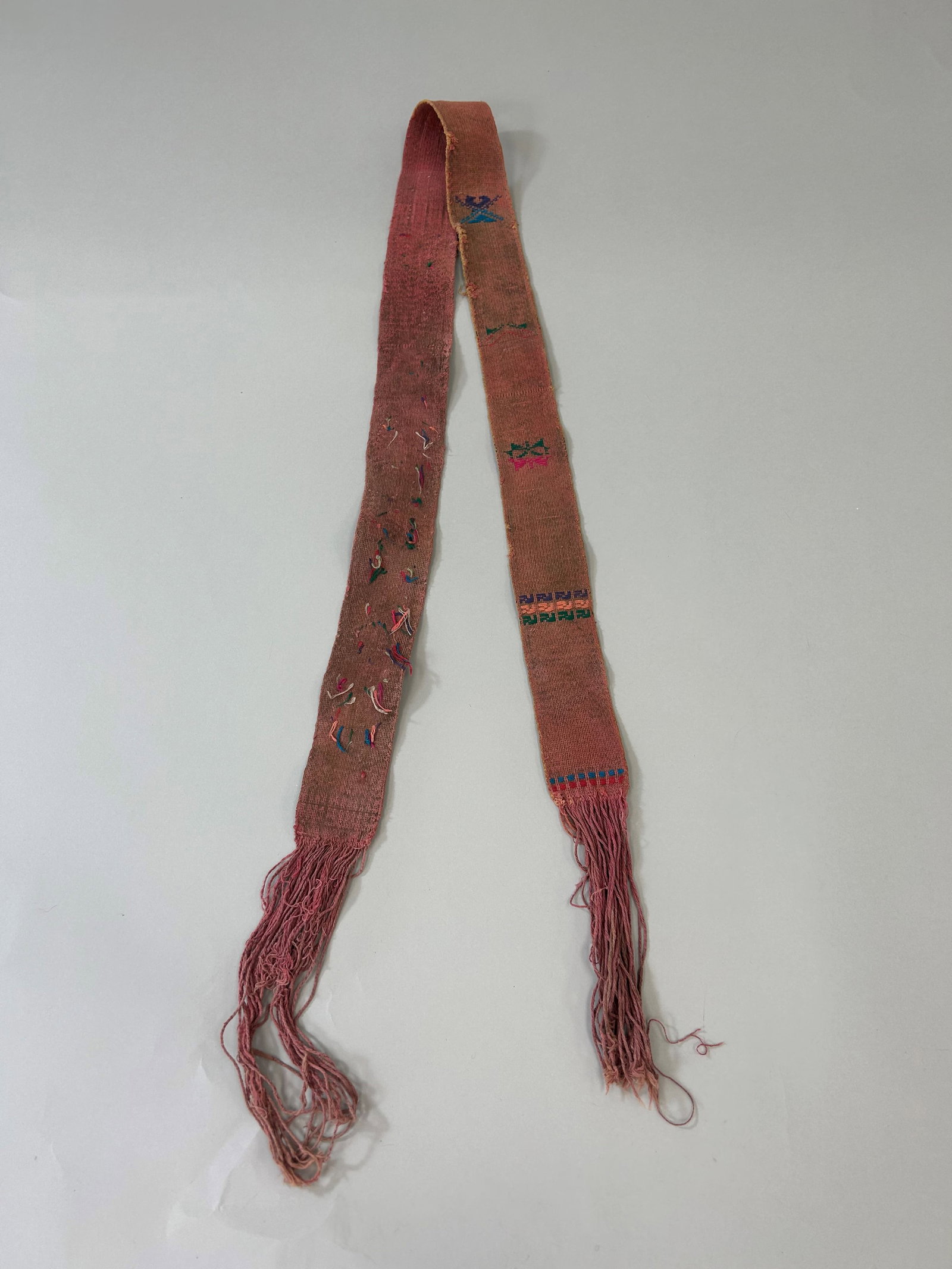 Bhutan Kira Embroidery Cotton Belt: Bhutan Kira Embroidery Cotton Belt, 48"l x 2"w (66''l with fringes) Provenance: From the estate of Dr. Philip Gould , New York