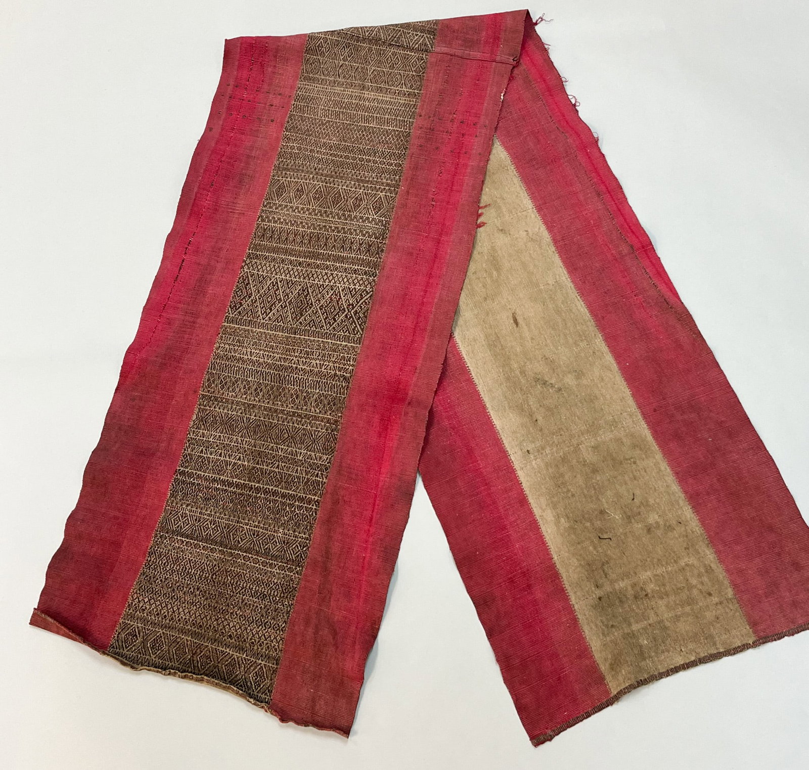 Ubon Ratchathani, Thailand, Vintage Woven Cotton Man's Sash: Ubon Ratchathani, Thailand, vintage woven cotton man's sash, raspberry color border, central area with traditional pattern, consists of two panels sewn together, 74"l x 15"w, 50"l x 28"w Provenance: F