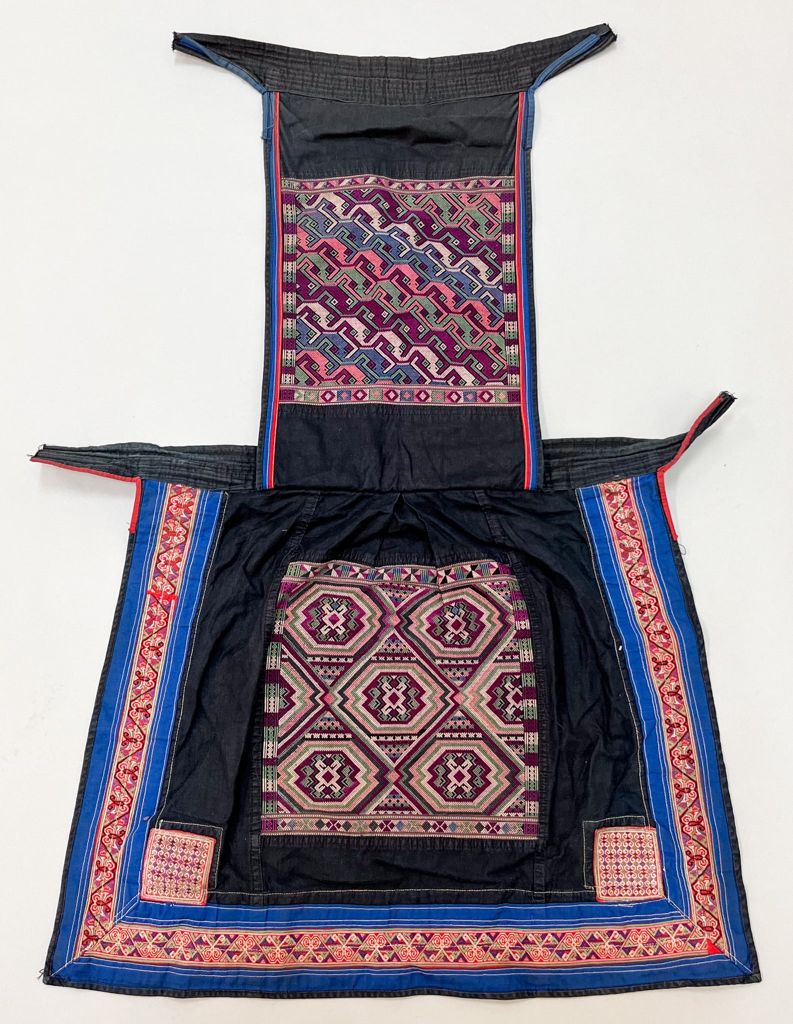 Miao, Yunnan Province, Southern China, Vintage Cotton Baby Carrier with Silk Embroidery: Miao, Yunnan Province, Southern China, vintage cotton with silk thread embroidery baby carrier, black ground with multicolor traditional pattern, 32"l x 19"w Provenance: From the estate of Dr. Philip 