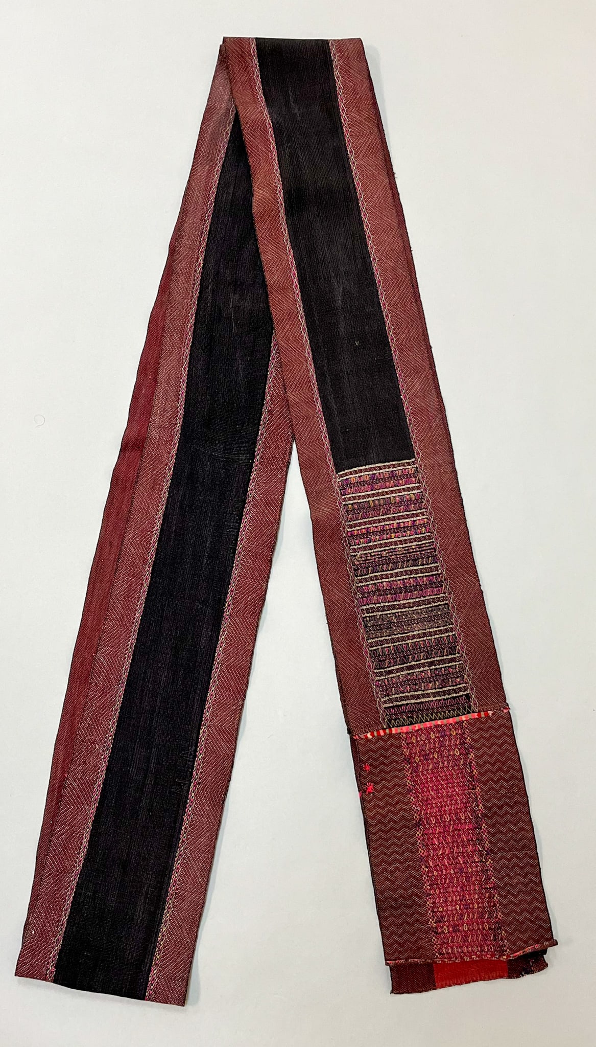 Myanmar (Burma), Vintage Woven Cotton Sash: Myanmar (Burma), vintage woven cotton sash, black band with embroidery traditional pattern accent, 169"l x 6"w Provenance: From the estate of Dr. Philip Gould , New York
