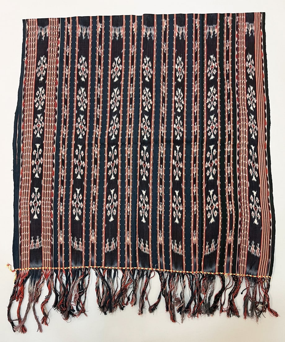Sawu, Indonesia, Vintage Woven Cotton Ikat Sarong: Sawu, Indonesia, vintage woven cotton ikat sarong, indigo ground with red stripe and traditional pattern, 67"l x 33"w Provenance: From the estate of Dr. Philip Gould , New York