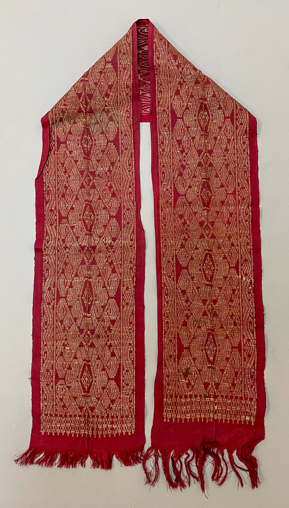 Bali, Indonesia, Vintage Silk and Metallic Silver-Tone Brocade Ceremonial Dowry Belt: Bali, Indonesia, vintage silk and metallic silver-tone brocade ceremonial dowry belt, burgundy ground with intricate traditional silver thread pattern, 48"l x 6"w Provenance: From the estate of Dr. Ph