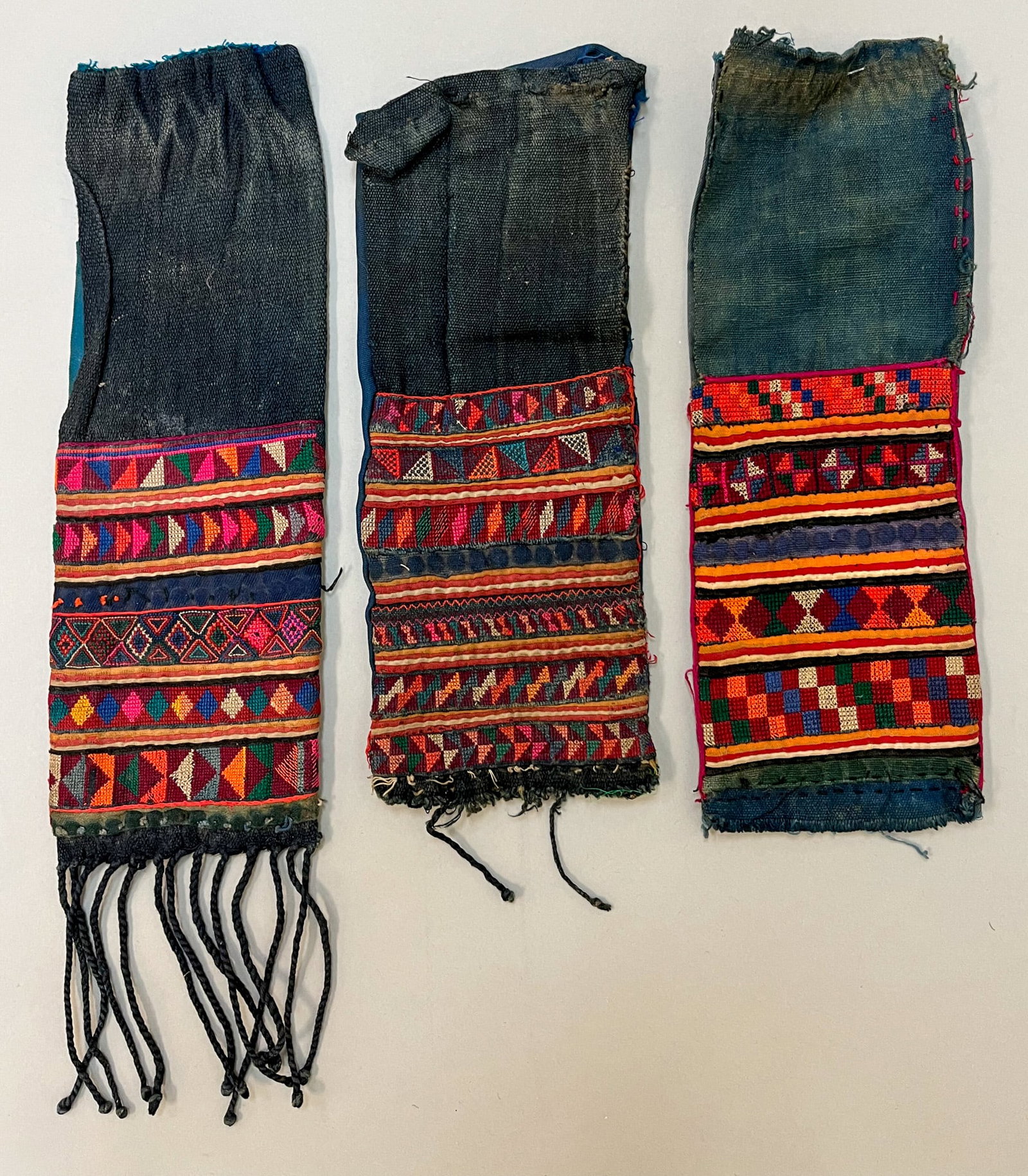 Akha, Yunnan Province, Southern China, Group of (3) Vintage Cotton Embroidery Loincloth: Akha, Yunnan Province, Southern China, group of (3) vintage cotton embroidery loincloth with colorful geometric tribe pattern, each 11"l x 4"w Provenance: From the estate of Dr. Philip Gould , New Yor