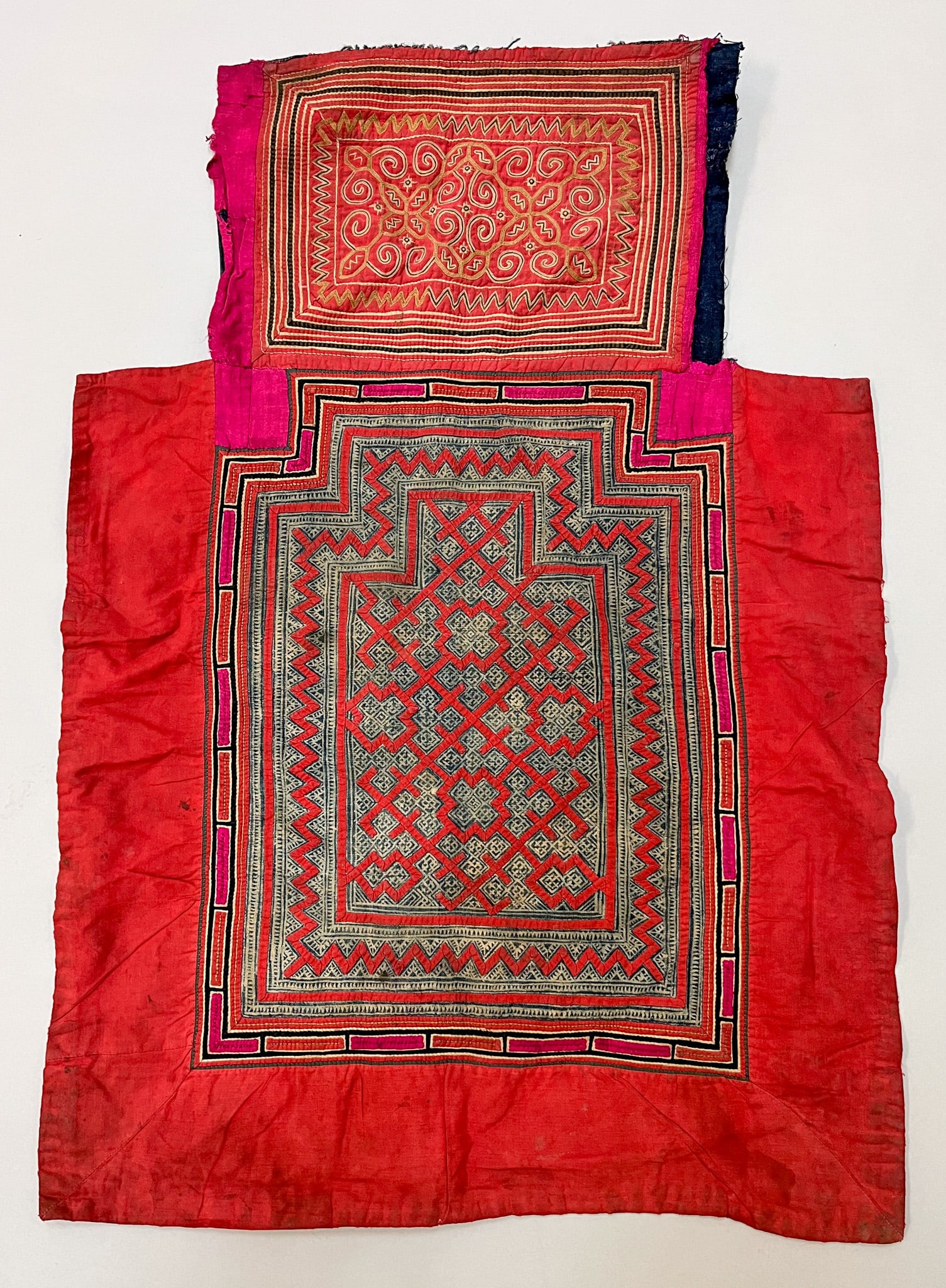 Hmong/Miao, South China, Vintage Cotton Possibly Baby Carrier: Hmong/Miao, South China, vintage cotton possibly baby carrier, orange ground with Ikat, applique, and embroidery pattern, 31"l x 21"w Provenance: From the estate of Dr. Philip Gould , New York