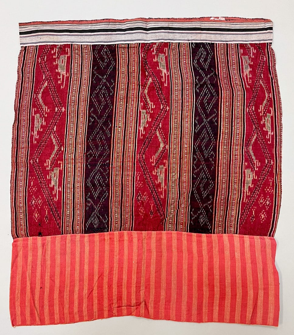 Possibly Tai Daeng People, North Laos, Vintage Cotton and Silk "Sinh" Tubular Sarong: Possibly Tai Daeng people, North Laos, vintage cotton and silk "Sinh" tubular sarong, ikat and silk thread embroidery, orange tone color stripes, 28"l x 24"w Provenance: From the estate of Dr. Philip 