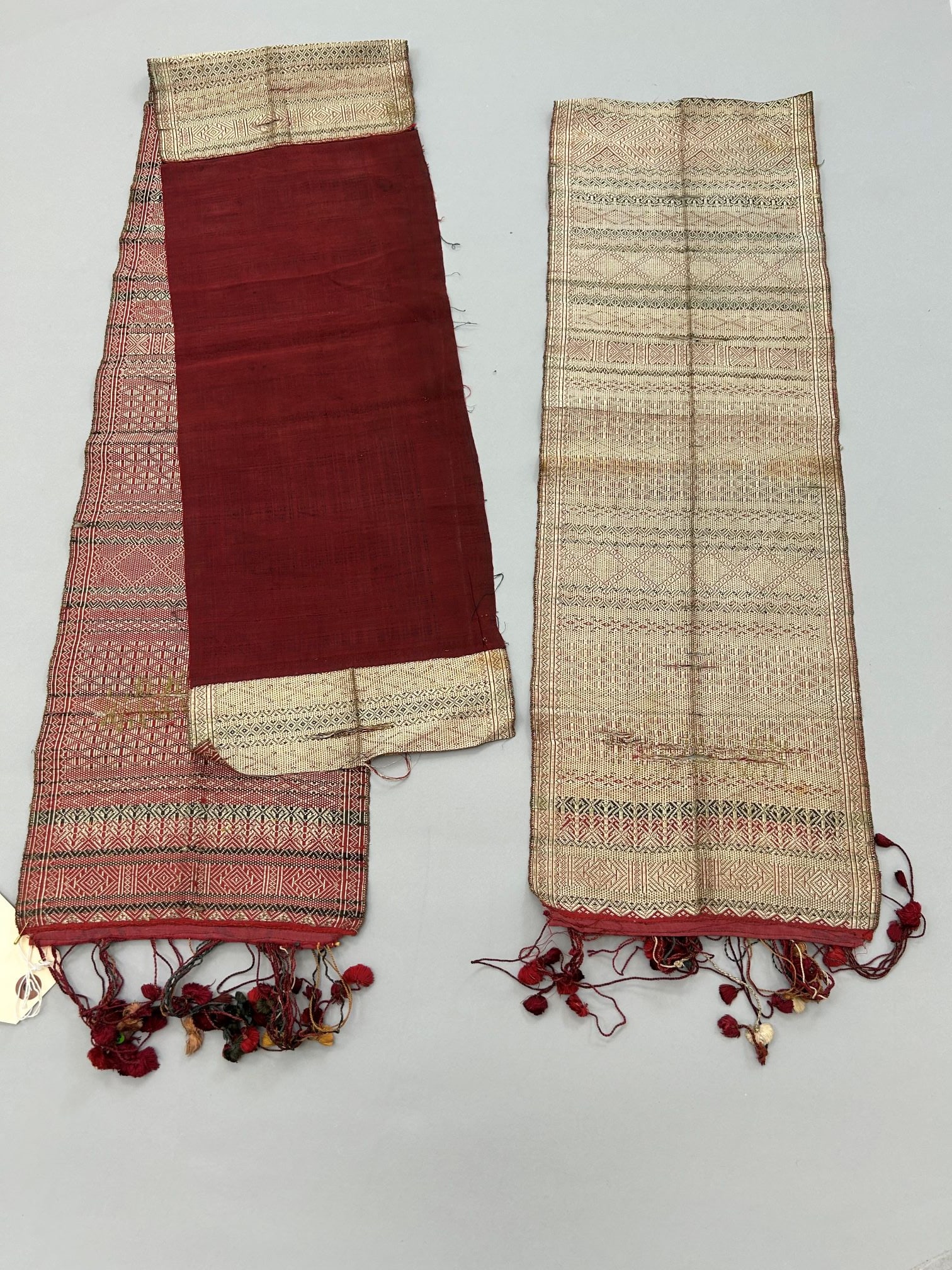 Indonesia, Sumatra, Minankabau, 2 Pieces of Silk Remnats with Metallic Gold Thread Patten: Indonesia, Sumatra, Minankabau, 2 pieces of silk remnats with metallic gold thread patten, 84"l x 9"w Provenance: From the estate of Dr. Philip Gould , New York