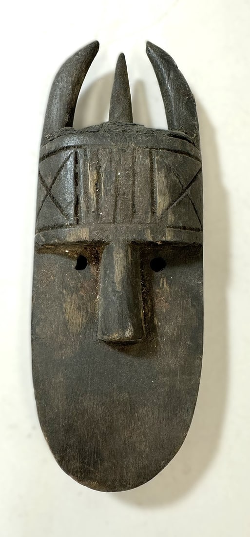 Toma Style Passport Mask: Toma style carved wood passport mask, Guinea, West Africa. Dimensions (approx.): 10" x 3.75" x 1.75" PROVENANCE:From the estate of Professor Philip Gould, New York