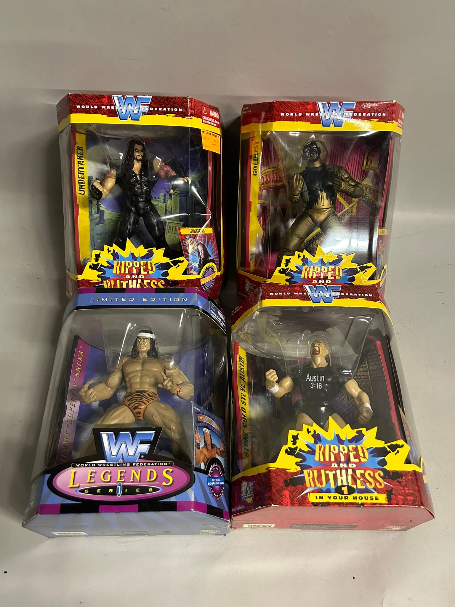 Collection of Jakks Pacific Ripped and Ruthless Series 1 and Legends Series 1 Wrestling Action: Includes Ripped And Ruthless Series 1 In Your House Stone Cold Steve Austin, Goldust, and Undertaker. Includes WWF Legends Series 1 Limited Edition Jimmy "Superfly" Snuka.
