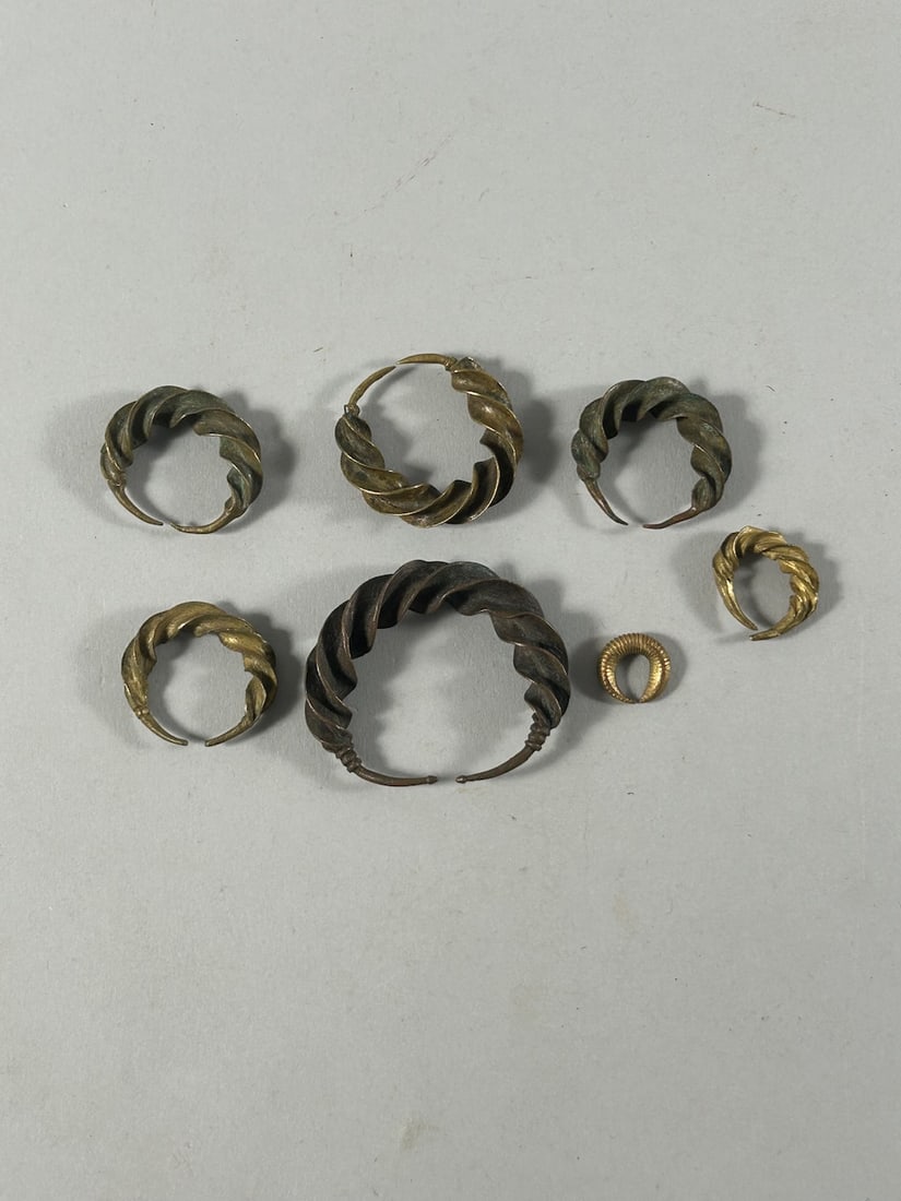 Senegalese 'Tarneih' Currency (7): A group of seven (7) currency pieces, in twisted golden-colored alloy form, Senegal, Republic of Senegal, West Africa. Dimensions (approx.): Max. diameter from 2' (largest) to 0.5" (smallest) PROVENAN