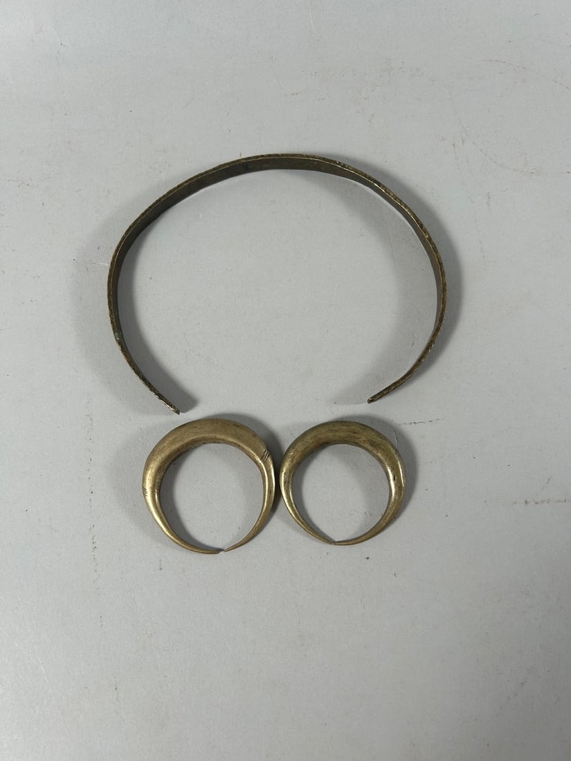 Earrings and Neck Torque: One pair of earrings, and an Ethiopian neck torque, East Africa. Dimensions (approx.): 2" drop (earrings), and 5" diameter (torque) PROVENANCE:From the estate of Professor Philip Gould, New York