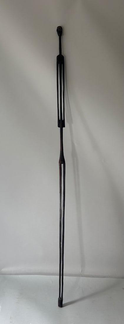 Tall Tanzanian Wood Carving: A tall wood carving from the United Republic of Tanzania, East Africa. Dimensions (approx.): 59.75" x 1.75" x 1" PROVENANCE:From the estate of Professor Philip Gould, New York
