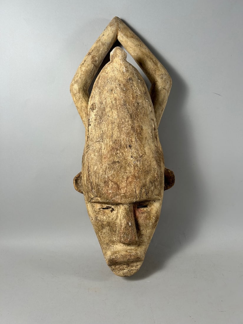 Igala Style Mask: Igala style carved wood mask, Nigeria, West Africa. Dimensions (approx.): 23" x 9" x 4.5" PROVENANCE:From the estate of Professor Philip Gould, New York