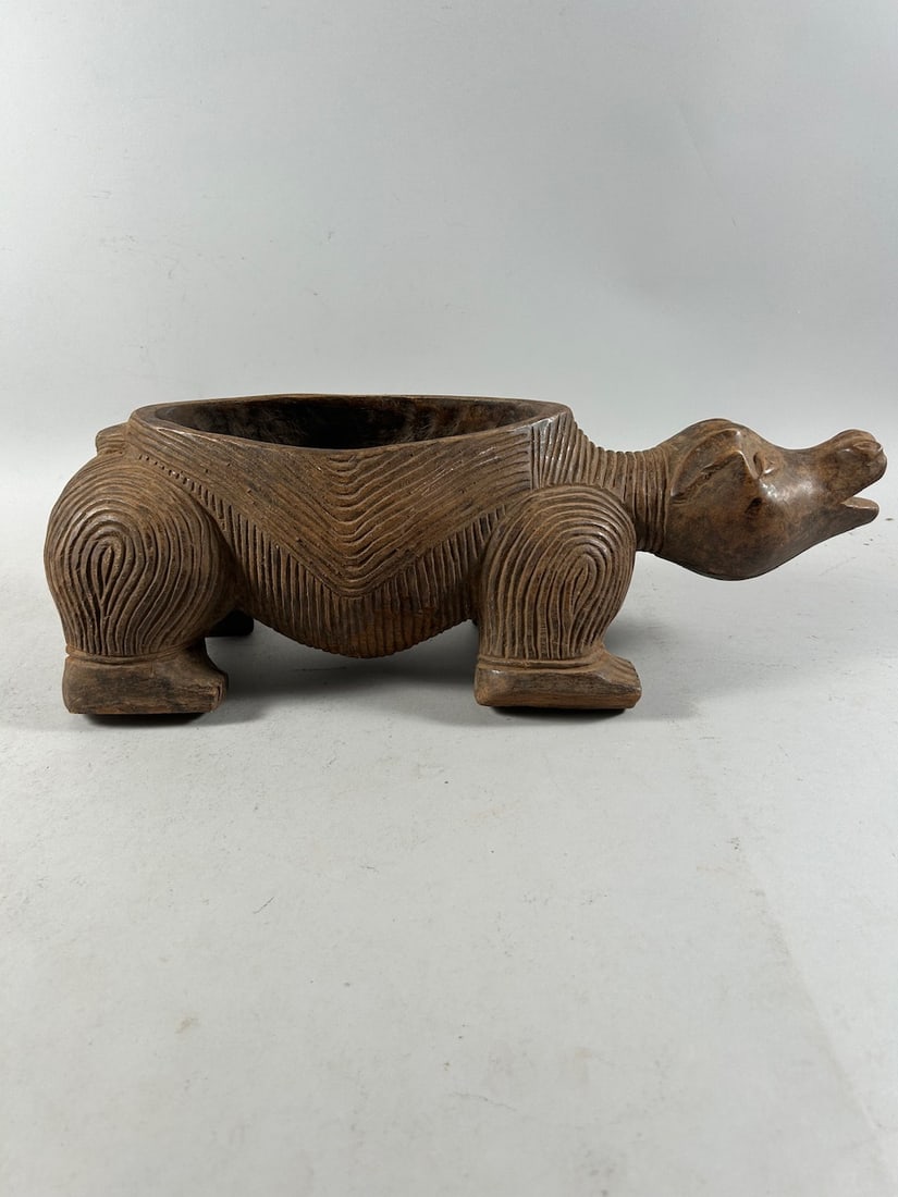 African Buffalo Wood Carving: A carved wood container in the form of a quadruped, possibly a buffalo, unknown culture, Africa. Dimensions (approx.): 18.5" x 6" x 6" PROVENANCE:From the estate of Professor Philip Gould, New York