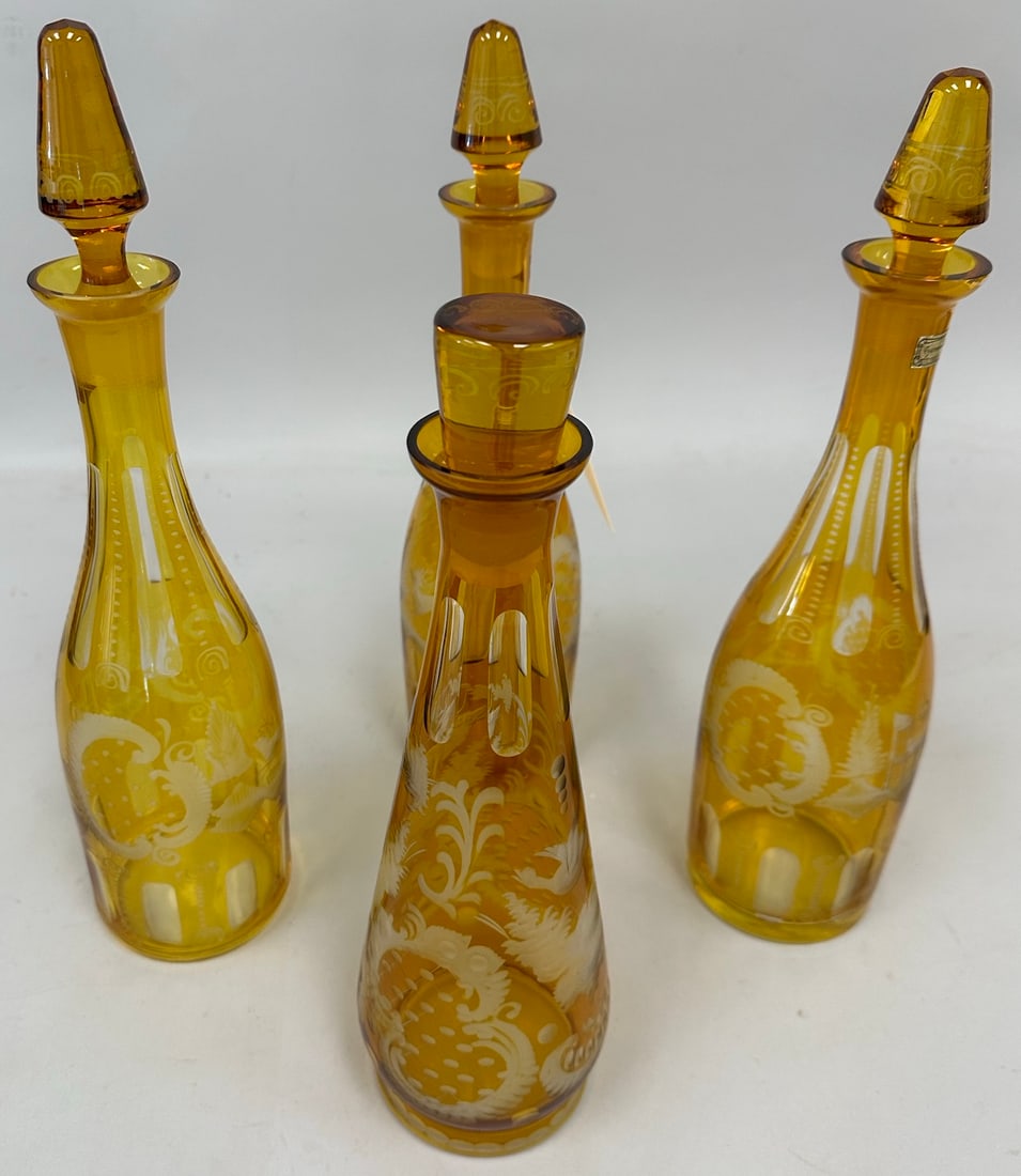 Lot of 4 - Vintage Egermann Amber Glass Decanters: Vintage Egermann Amber Glass Decanters with original stopper. Expertly crafted etched patterns of classic Bohemian style glassware. Tallest 15" x 4 " D. Shortest 13" x 4" D.