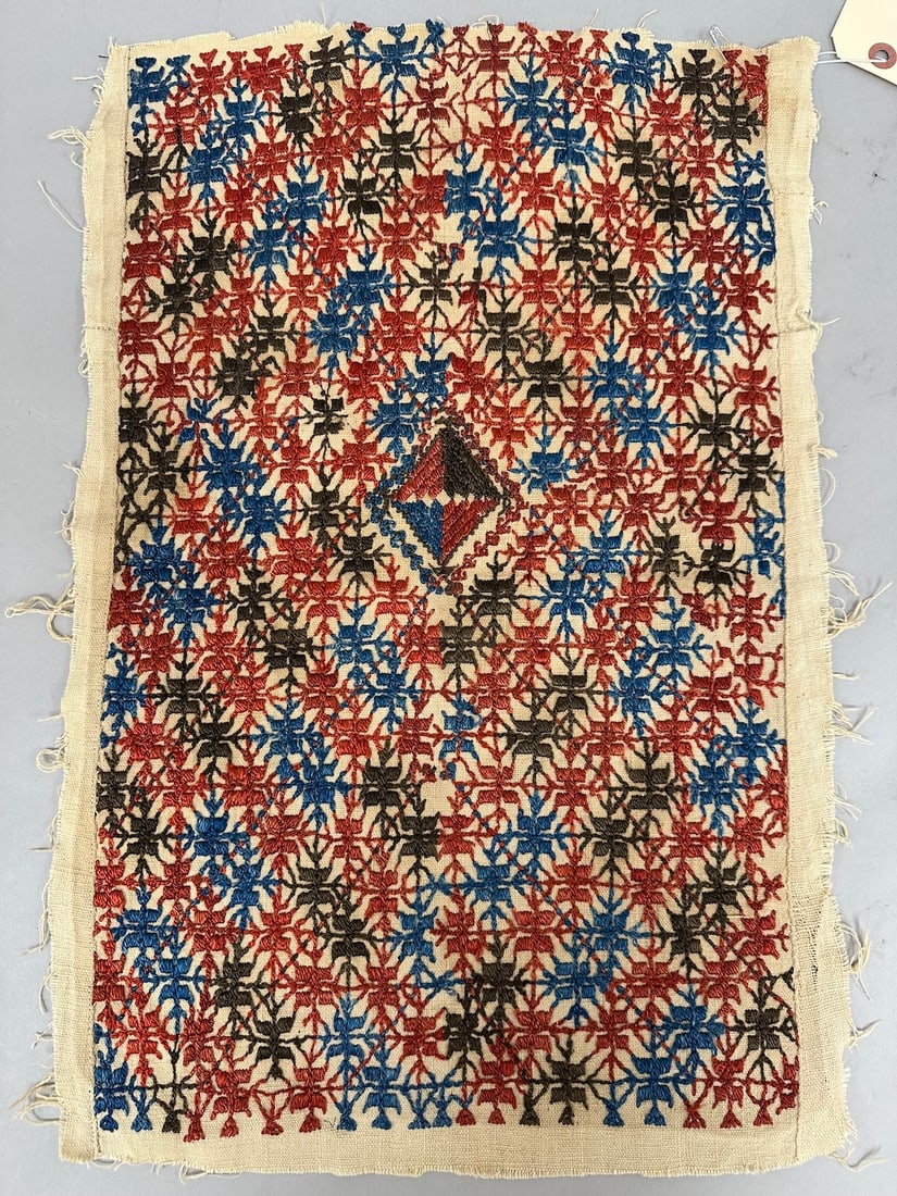 Traditional Possibly Ukrainian Embroidered Fabric: Embroidered fabric with geometric pattern in red, blue, and brown thread on a beige background. It's possibly a traditional Ukrainian embroidery Rushnyk. D: 14" W x 21" L.