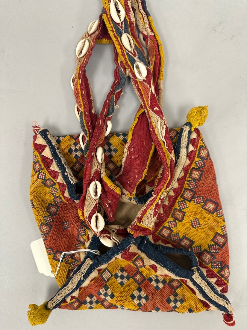 Embroidered Banjara Antique Vintage Bag: Indian vintage tribal ethnic Rabari Kutchi dowry marriage bag with vibrant colors, embroidered with the use of sea shells and beads. Colors include red, yellow, and navy blue. D: 8" square x 16" L.